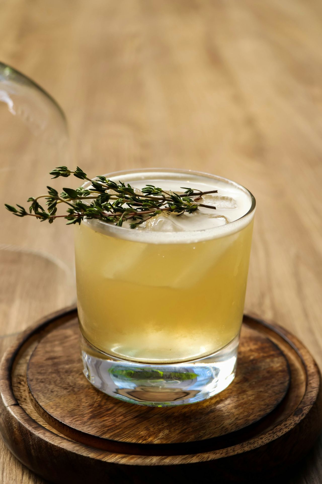 Mint'beer a glass of yellow liquid with a plant on top